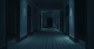A tense hotel hallway with closed doors, dim lighting, and an eerie atmosphere, depicting a sense of danger and unease.