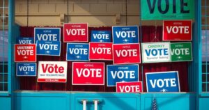 Voting booth with colorful campaign signs for New Jersey gubernatorial candidates in an election atmosphere.
