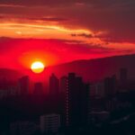 A sunset in Johannesburg with dark city shadows, symbolizing safety struggles for women against crime.