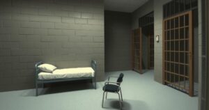 A detention cell with a simple setting, showcasing a bed, a table, and a dim light, in muted colors.