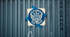 A closed container with a poorly attached Ukrainian Air Force logo and unreadable Cyrillic script.
